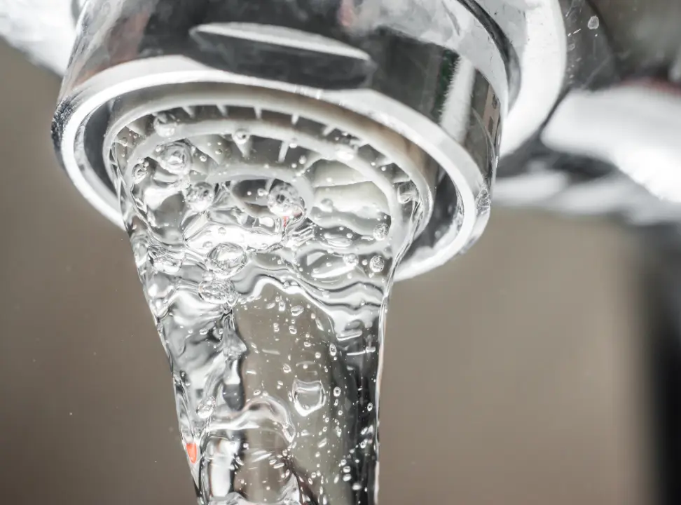 Unscrewing a Faucet Aerator for Inspection and Cleaning